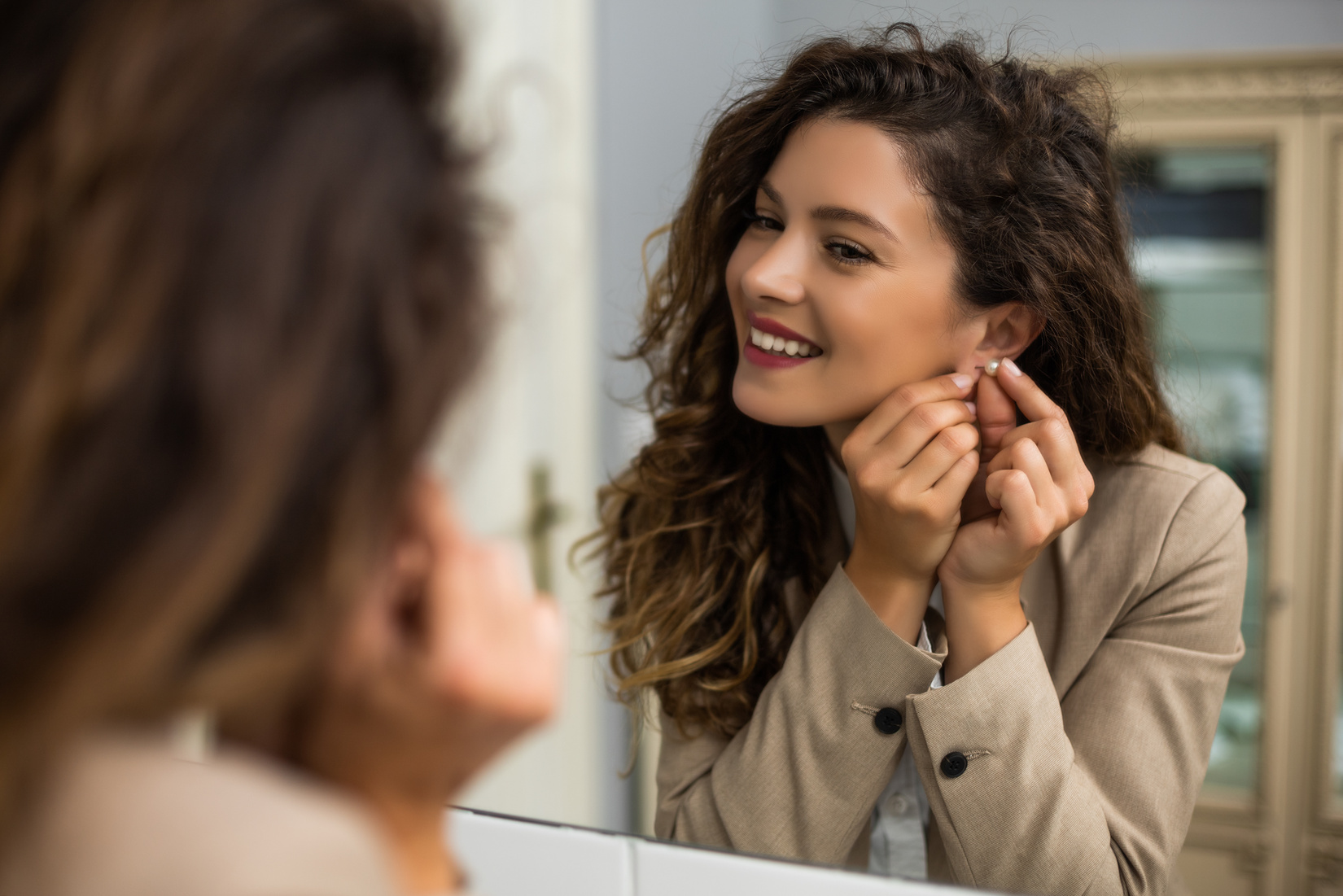 Woman putting earrings